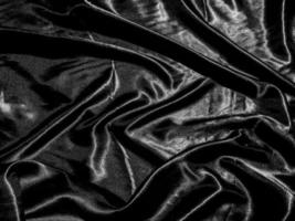 luxury black silk or satin texture background with liquid wave or wavy folds. Wallpaper design photo