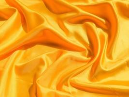 Bright yellow silk with waves moving for background. Abstract design with copy space photo