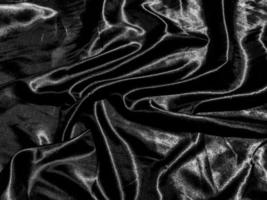 luxury black silk or satin texture background with liquid wave or wavy folds. Wallpaper design photo