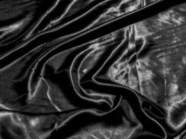 luxury black silk or satin texture background with liquid wave or wavy folds. Wallpaper design photo