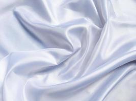 white crumpled fabric texture background. Silk curtain with fold waves for design photo