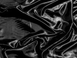 luxury black silk or satin texture background with liquid wave or wavy folds. Wallpaper design photo