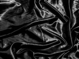 luxury black silk or satin texture background with liquid wave or wavy folds. Wallpaper design photo