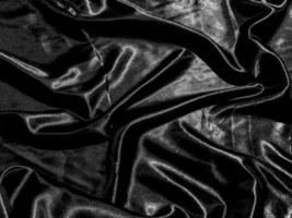 luxury black silk or satin texture background with liquid wave or wavy folds. Wallpaper design photo