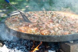 Preparing paella in large pan photo