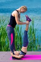 Little girt and woman are doing exercises photo