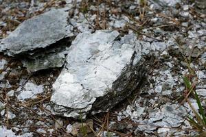 Macro photography of unprocessed pieces of mica minerals in a natural deposit. photo