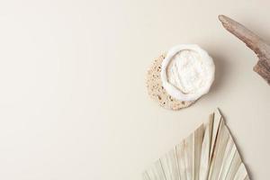 Collagen powder with palm leaf on pastel beige background. Flat lay, copy space photo