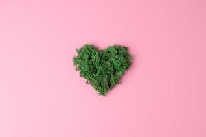 Minimal composition with moss on pink background. Flat lay, copy space. photo