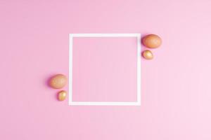 Easter beige and golden eggs on a pink background with white frame. Flat lay, copy space. photo