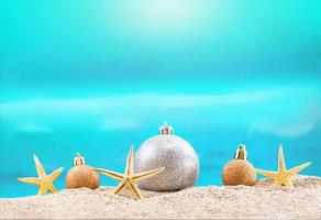 Starfish and Christmas tree shiny balls on beach. Sunny. Concept holiday and recreation, travel in hot countries. New Year. Copy space photo