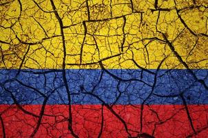 Dry soil pattern on the flag of Colombia. Country with drought concept. Water problem. Dry cracked earth country. photo