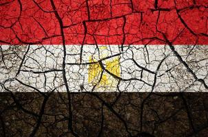 Dry soil pattern on the flag of Egypt. Country with drought concept. Water problem. Dry cracked earth country. photo