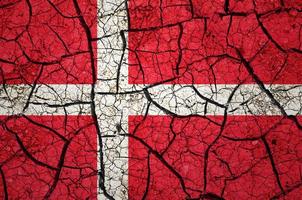 Dry soil pattern on the flag of Denmark. Country with drought concept. Water problem. Dry cracked earth country. photo