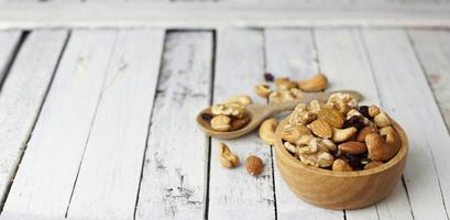 Bowl of mixed nut for healthy life on wwoden table photo