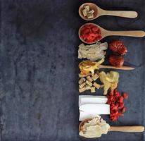 Top view Group of chinese medicine herbs on black background photo