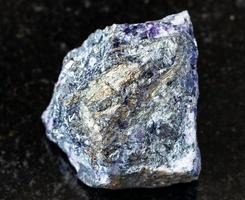 rough Stibnite Antimonite ore on black photo