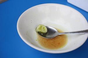 the bowl has been used for soto rice with used lime slices photo