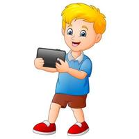 Cartoon little boy playing a tablet vector