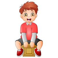 Cute little boy sitting on a cube vector