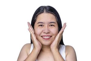 Portrait of gorgeous happy middle aged mature Asian woman, senior older 40s year lady looking at camera touching her face isolated on white background. Ads of lifting anti wrinkle skin care treatment. photo