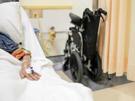 A patient resting on the hospital bed receiving medical care photo