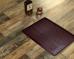 New Delhi, Delhi, IN, 2022 - Chocolate Black Leather textured welcome door mat placed with Whiskey and Glass photo