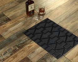 New Delhi, Delhi, IN, 2022 - Black Stylish upside arrow patterned entry door mat placed with Whiskey and Glass photo