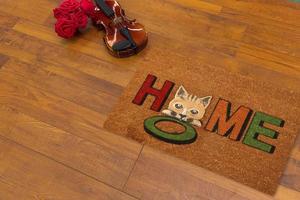 New Delhi, Delhi, IN, 2022 - Beautiful Colorful Little Hello Kitty Welcome zute doormat with HELLO placed on brown floor with Guitar photo