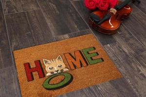 New Delhi, Delhi, IN, 2022 - Beautiful Colorful Little Hello Kitty Welcome zute doormat with HELLO placed on brown floor with Guitar photo