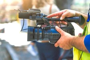 Camera in the hands of a journalist cameraman photo