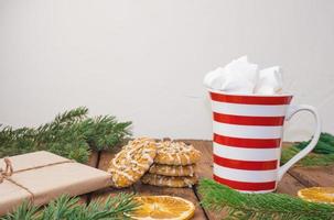 sweet hot cocoa with marshmallows, winter christmas drink on wooden background. photo