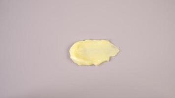 Cosmetic products creamy yellow texture stain nude beige background. The texture of natural cosmetics hair mask, cream, scrub. photo