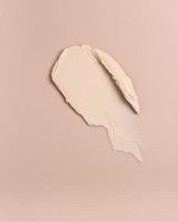 Pink creamy foundation texture background. photo