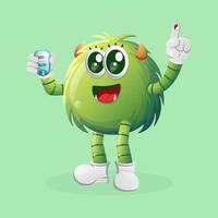 Cute green monster holding a blood glucose meter vector