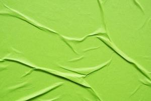 green crumpled and creased paper poster texture background photo