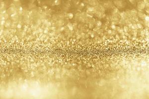 Abstract gold glitter sparkle with bokeh background photo