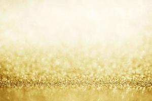 Abstract gold glitter sparkle blurred with bokeh background photo