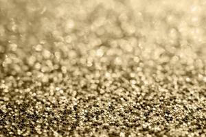 Abstract gold glitter sparkle blurred with bokeh background photo