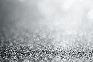 Abstract silver glitter sparkle texture with bokeh background photo