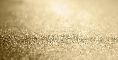 Abstract gold glitter sparkle with bokeh background photo