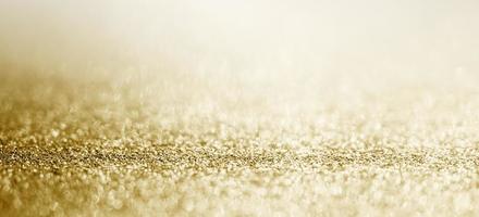 Abstract gold glitter sparkle with bokeh background photo