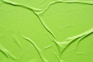 green crumpled and creased paper poster texture background photo