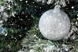 Decorated Christmas ball on tree New Year holidays background photo