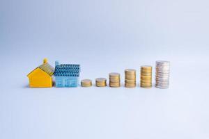 Colorful house and coins using as property and finance concept photo