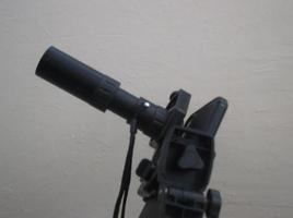 Attachment between monocular telescope and smartphone on a tripod photo