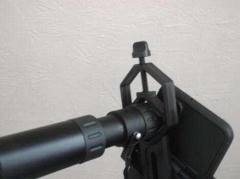 Attachment between monocular telescope and smartphone on a tripod photo