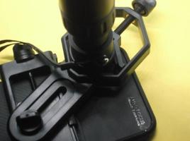 Attachment between monocular telescope and smartphone on a tripod photo