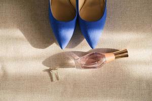 The bride's wedding accessories are white and blue. shoes, perfume, and sergi close-up. Top view photo