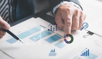 Businessmen analyze market reports with statistics from charts and graphs, managing business and financial strategies, professional analysts view investment information, consulting and presentations. photo